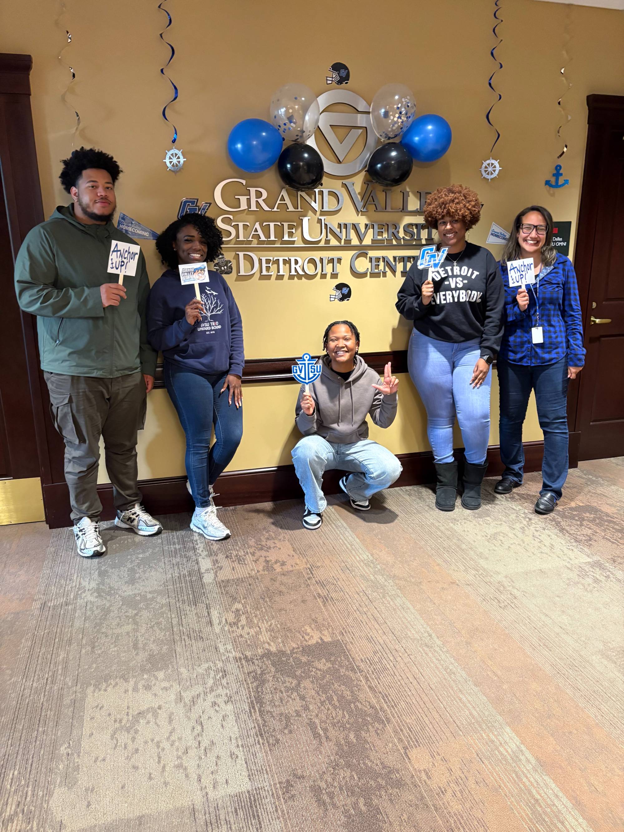 Detroit Center team smiling with their Homecoming decorations